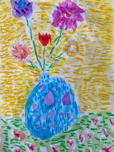 A light blue flower vase against a bright yellow background with five different colored flowers in it.