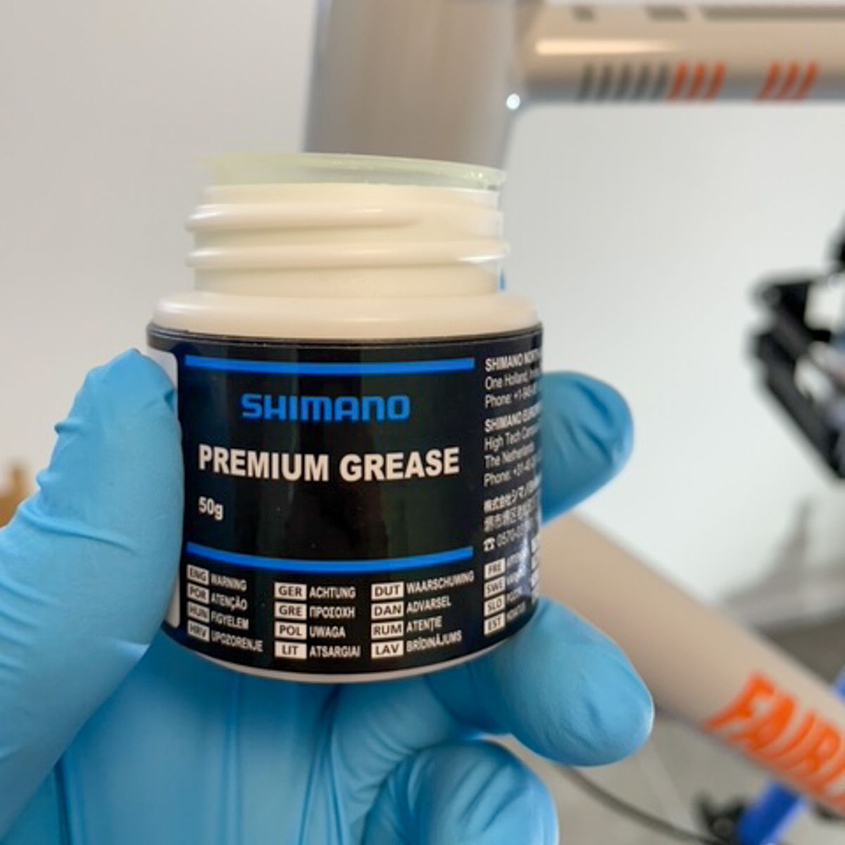 A plastic can with Shimano quality grease